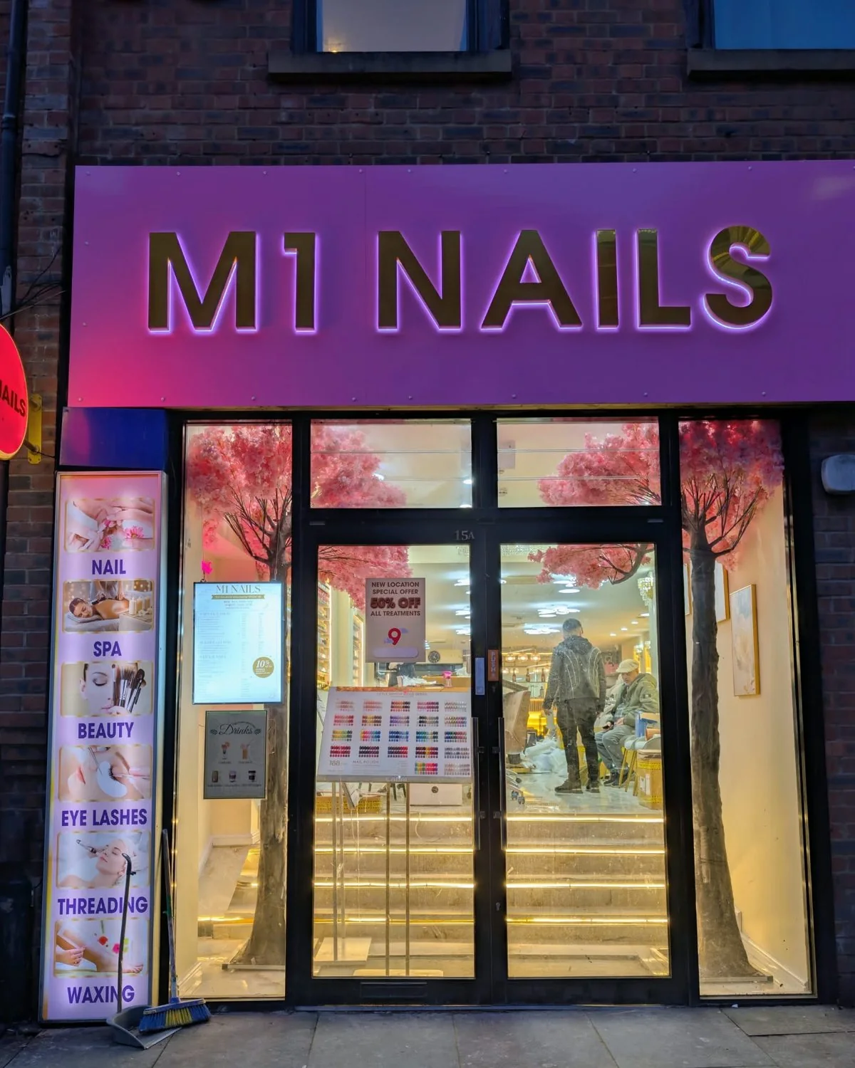 The M1 Nails shopfront at night